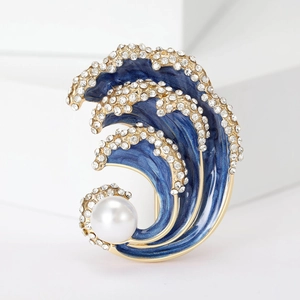 Elegant blue enamel sea wave brooch with sparkling crystals and a white pearl on a gold base