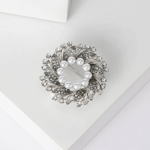 Elegant silver alloy floral wreath brooch with white pearls and sparkling rhinestones