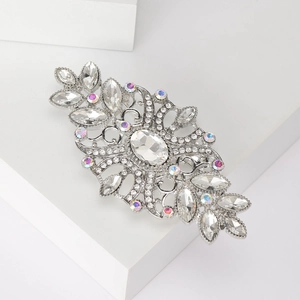 Macro view of vintage silver brooch featuring clear crystals and an oval rhinestone