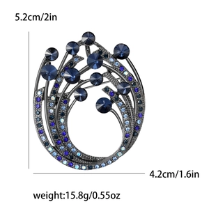 Elegant swirl brooch with deep blue crystals and gradient rhinestones on black nickel