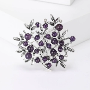 Elegant silver tree branch brooch with purple pearls and crystal accents on white base