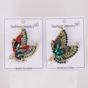 Detailed close-up of retro butterfly brooches with colorful rhinestones and pearls