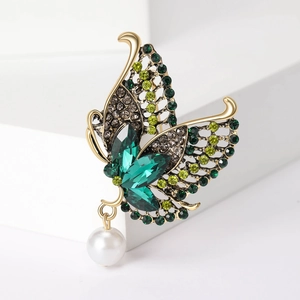 Elegant gold hollow butterfly brooch with green rhinestones and a white pearl drop