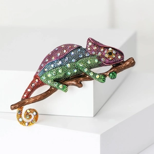 Macro shot of chameleon brooch with colorful rhinestones and gradient enamel coating