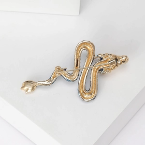 Exquisite golden dragon brooch with blue enamel inlay shown from the back perspective