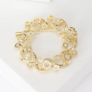 Elegant gold olive branch brooch with zircon stones showing detailed back safety pin view