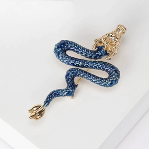 Exquisite enamel Chinese dragon brooch with gold-toned details on white display
