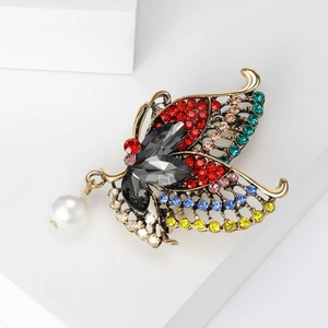 Vintage alloy butterfly brooch with colorful rhinestones and hanging pearl on white base