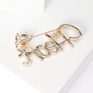 Golden LOVED letter brooch with Cupid angel design and sparkling diamond accents