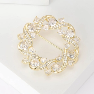 Elegant gold olive branch wreath brooch with micro-pave cubic zirconia crystals