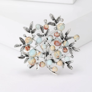 Detailed close-up of tree brooch with vintage silver alloy leaves and colorful stone beads