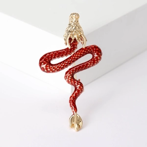 Detail view of a premium red enamel dragon brooch with intricate gold textured scales