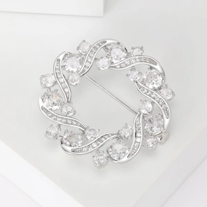 Detail of silver wreath brooch with micro-paved cubic zirconia and pin fastening mechanism