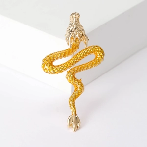Close-up of a high-end enamel Chinese dragon brooch with intricate golden metal details