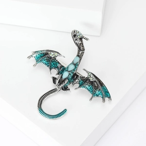 Exquisite fantasy dragon brooch with blue enamel and water-drop gemstones on white podium