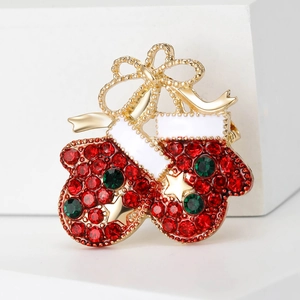 Christmas gloves brooch with red rhinestones and gold star on white display