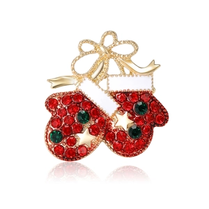 Christmas red glove brooch with rhinestones and golden bow on white background