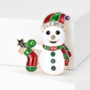 Broche bonhomme de neige de Noël avec émail et cristaux verts sur socle blanc