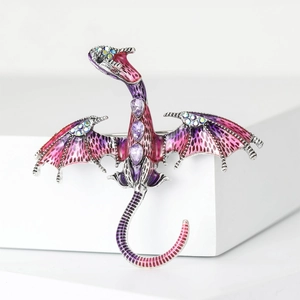 Macro shot of purple enamel dragon brooch with purple gems and colorful rhinestones