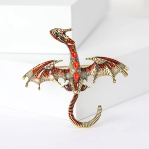 Detailed view of the enamel dragon brooch with intricate red wings and ruby rhinestones