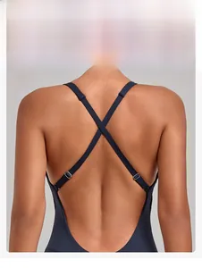 Detail view of the criss-cross back straps with metal adjustment buckles on a yoga jumpsuit