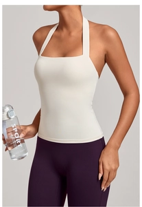 Détail d'un débardeur de sport blanc dos nu et d'un legging de yoga violet taille haute