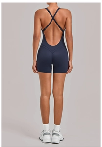 Close-up of navy blue yoga romper featuring cross-back straps and V-shaped back design
