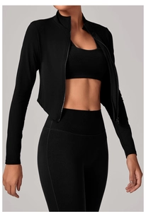 Détail de la veste noire à col montant zippé et du pantalon de yoga taille haute