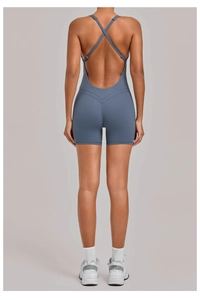 Close-up of cross-back straps and open back detail on a dark grey-blue yoga bodysuit
