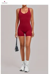 Detail of ruby red one-piece yoga romper featuring a backless cross strap design