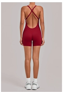 Detail of cross-back straps and butt-lifting design on a burgundy yoga romper for women