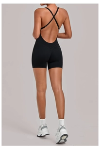 Detail of black cross-back yoga bodysuit with open back design and smooth fabric