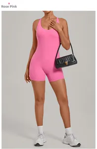 Detail view of women's rose pink yoga bodysuit with cross back and athletic fit