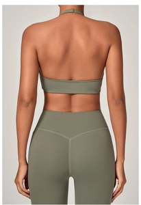 Dettaglio del reggiseno sportivo allacciato al collo verde oliva e leggings yoga a vita alta