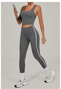 Detail view of dark grey high-waist yoga set with vertical side stripes and slim fit crop top