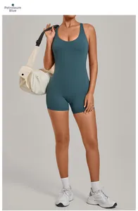 Detail of petroleum blue one-piece yoga romper featuring a crisscross back and slim fit design