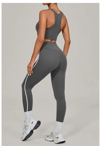 Detail of high-waisted yoga set with side stripe and racerback sports bra in dark grey