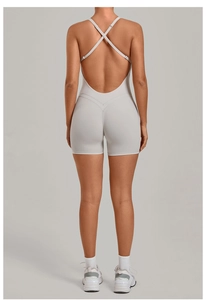 Detail view of the criss-cross back straps and high-elastic fabric of the yoga bodysuit