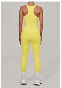 Rear view of vibrant yellow high-waisted yoga leggings and sports tank top set