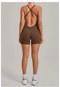 Close-up of brown one-piece yoga jumpsuit featuring a backless cross-strap design