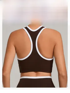 Detail of racerback sports bra in dark brown with white piping showing back muscle definition