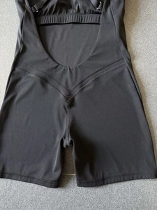 Detail view of the open-back design and scrunch butt stitching on black yoga jumpsuit