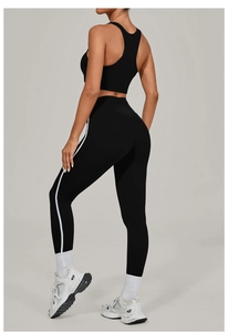 Detail view of black yoga set showing racerback sports bra and high-waisted striped leggings