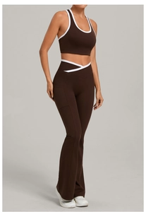 Detail of dark brown yoga set featuring V-cross waistband and side pockets on flare pants