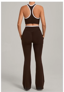 Rear view of dark brown yoga set with white contrast trim on sports bra and flared pants