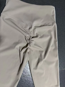 Detail view of high waist yoga leggings with scrunch butt design and side stripe