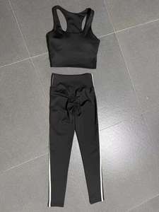 Flat lay of black two-piece yoga set featuring scrunch butt leggings and racerback top