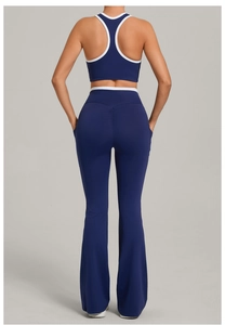 Detail of navy blue flare yoga pants with white piping and racerback tank top rear view