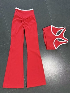 Detail view of red yoga set featuring flared leggings and a backless top with white piping