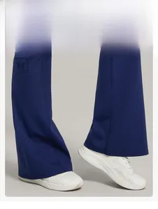 Detail showing flared leg design of navy yoga pants with a stylish slimming silhouette